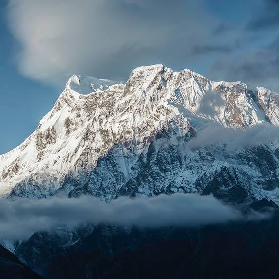 Trekkers on the Annapurna Circuit with snow-capped Himalayan peaks in the background