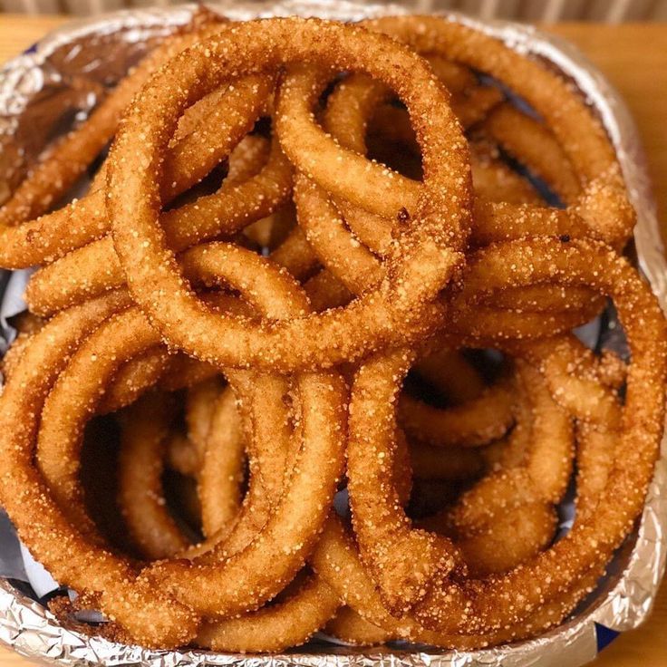Golden-brown Sel Roti, the ring-shaped Nepali rice bread, stacked on a plate
