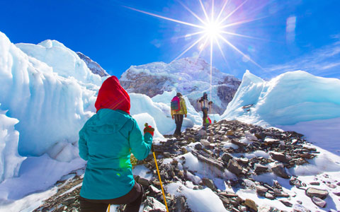 Trekkers on a trail in the Nepal Himalaya with mountain views
